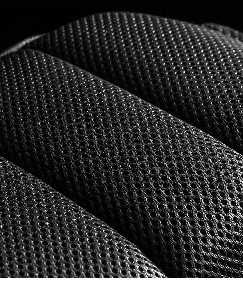 Close-up of black breathable mesh fabric with ergonomic padding and textured detail