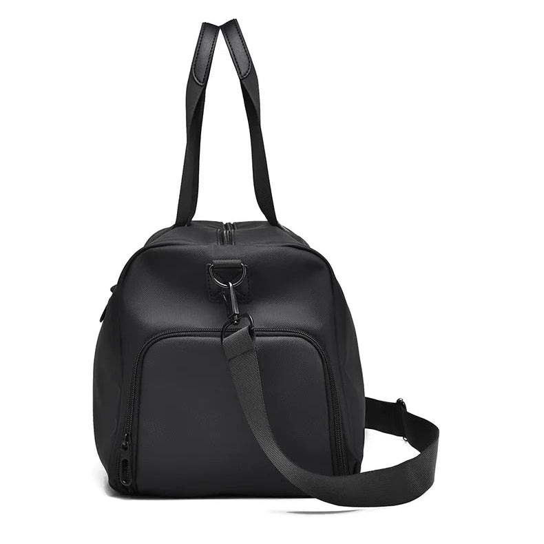 Black urban duffel bag with dual top handles and front zip pocket on white background
